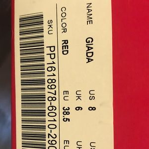 Red heels with a bow around the ankle. NEVER WORN